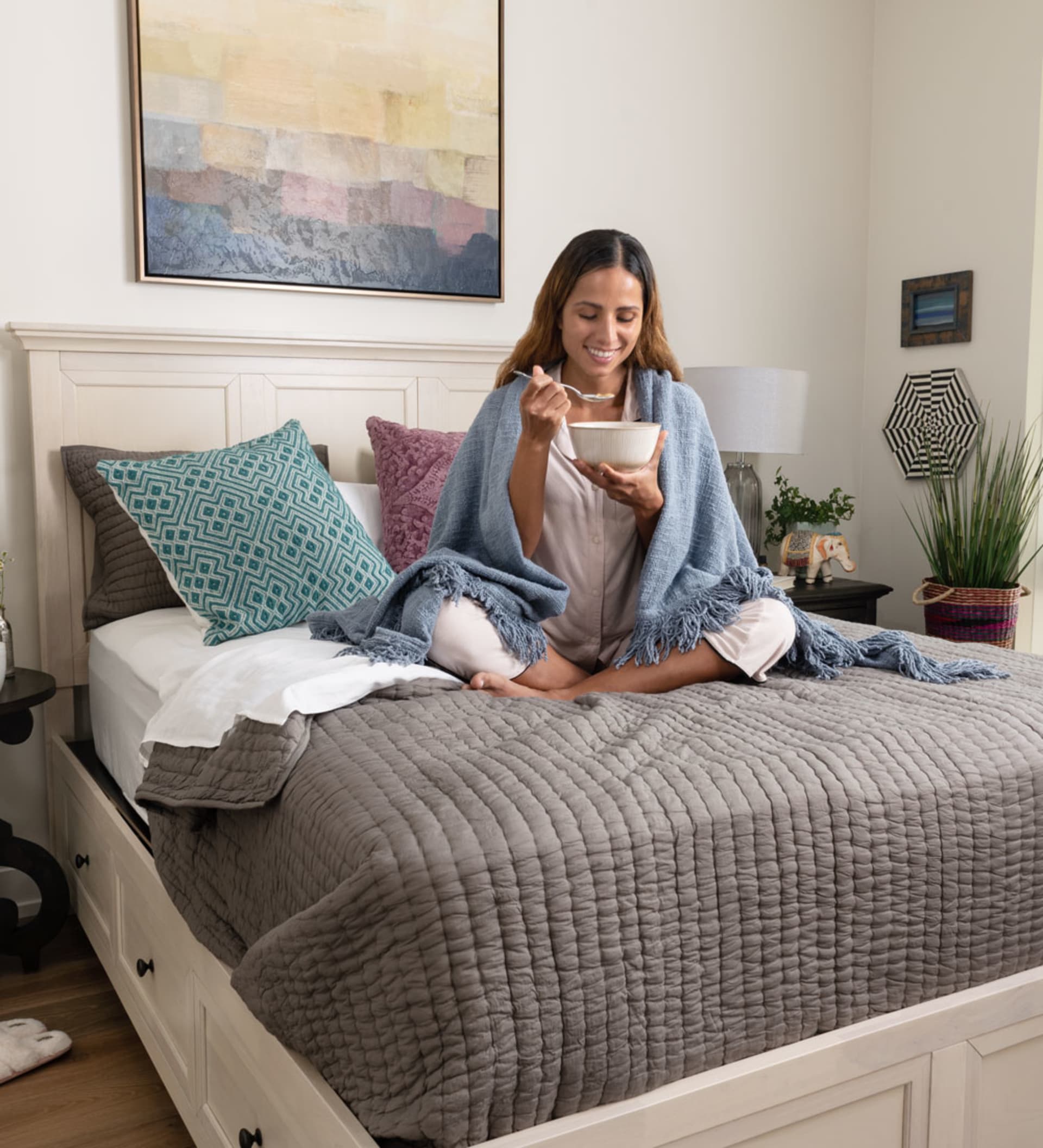 Woman eating cereal on Bonn Storage Bed