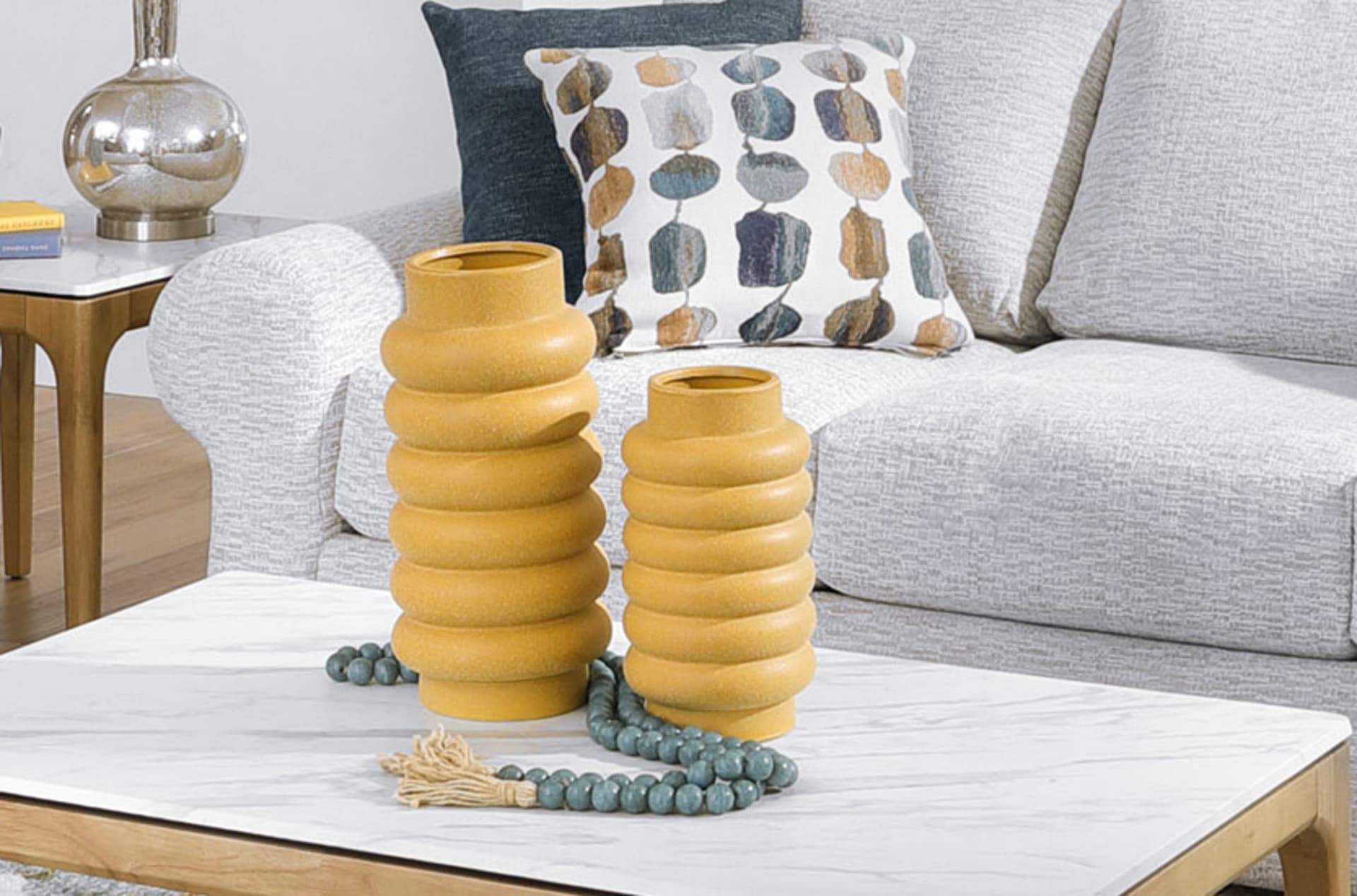 Bright Yellow Vases with Unique organic shape in living Room with Colorful Pillows.