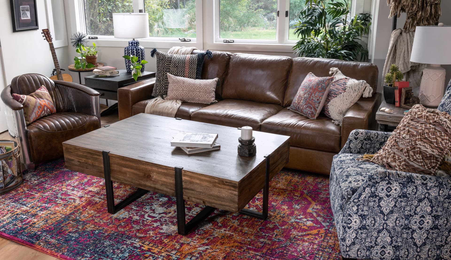 Brown leather sofa with brown leather club chair and coffee table in living room window shot