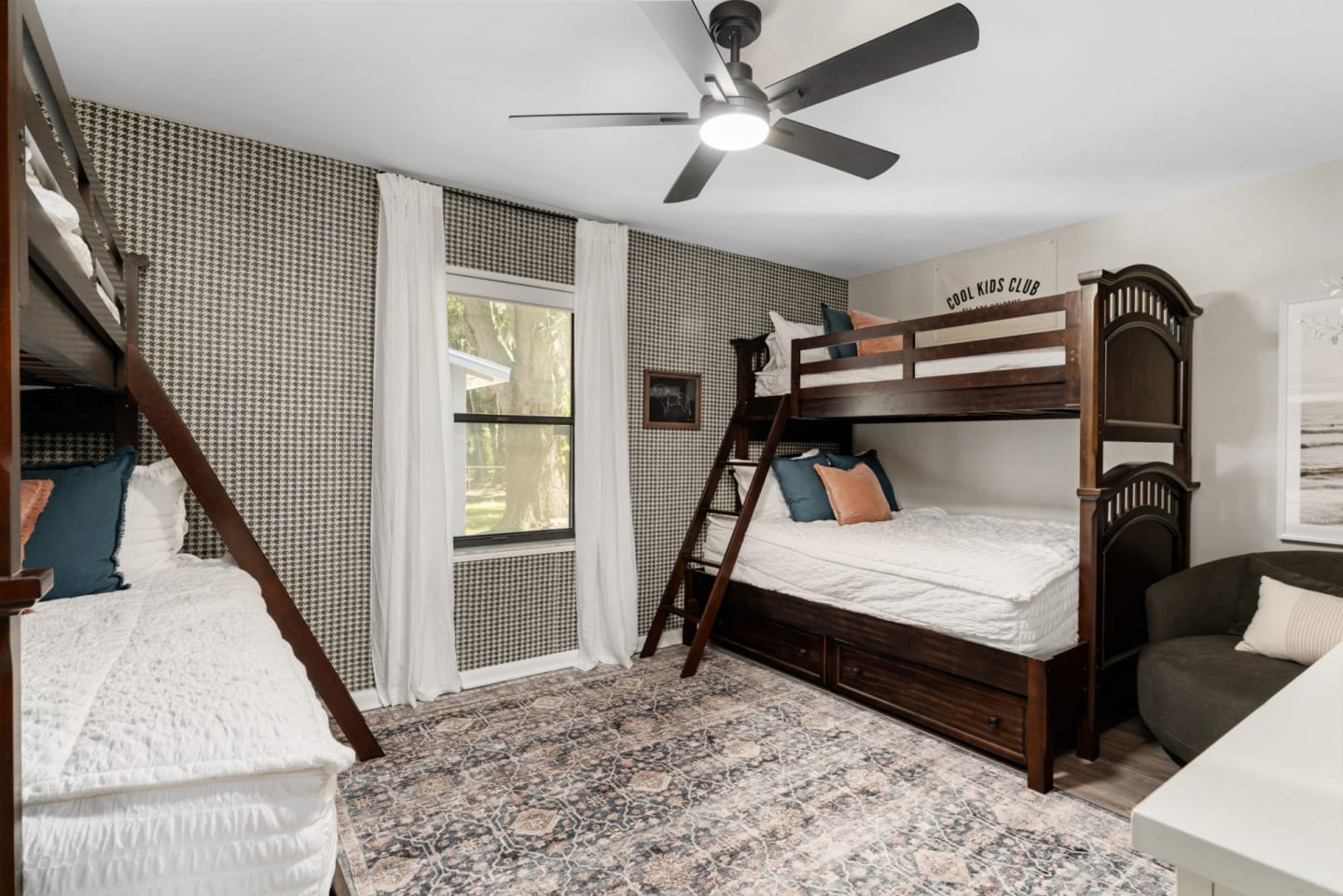 A twin over full bunk bed made from wood in a dark finish in a bunk bed room