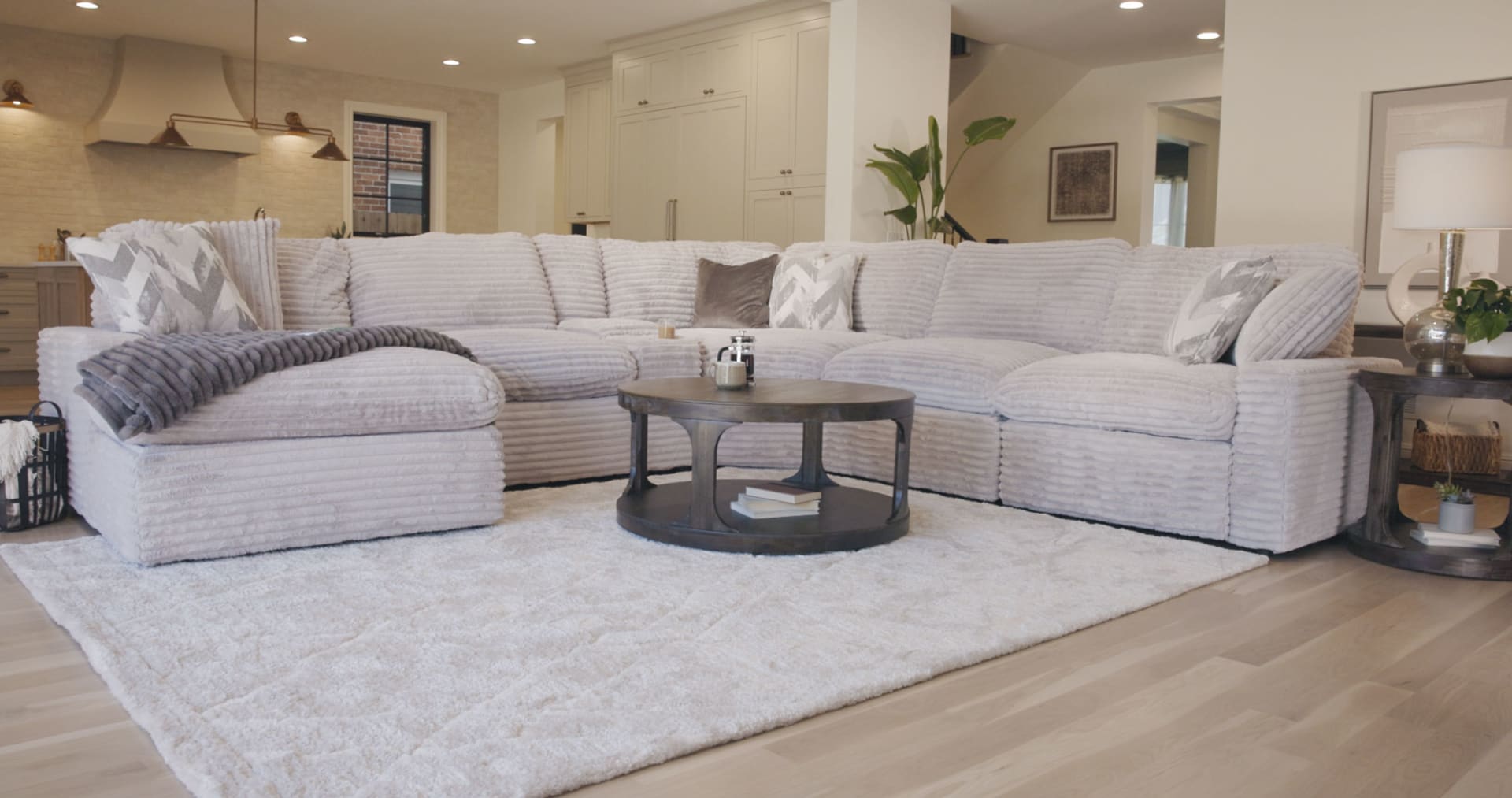 Light Gray power reclining sectional in living room with channeled fabric