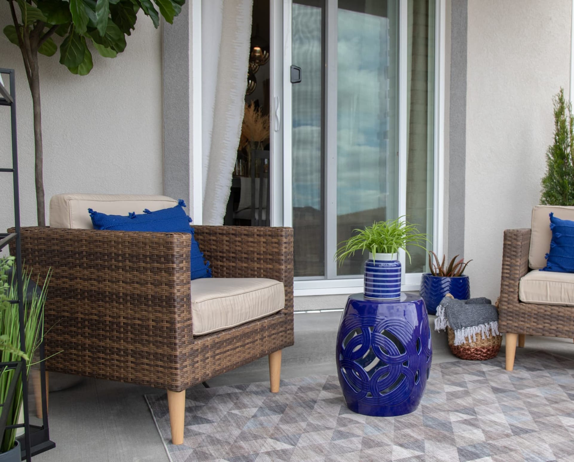 The San Bruno 4 Pc. Patio Set styled with vibrant blue accents on a patio